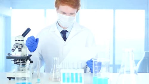 Scientist Analyzing Data and Using Microscope in Lab