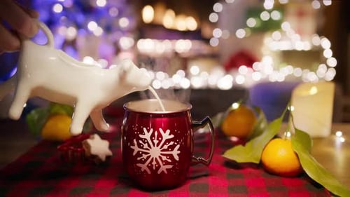 Creamer Pitcher in Cow Shape Spilling Hot Milk on Chocolate Bomb Floating Cocoa