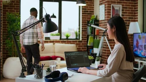 Woman Working on Laptop with Computer Code