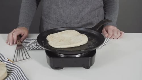 Preparing Homemade Flatbread on a Castiron Skillet