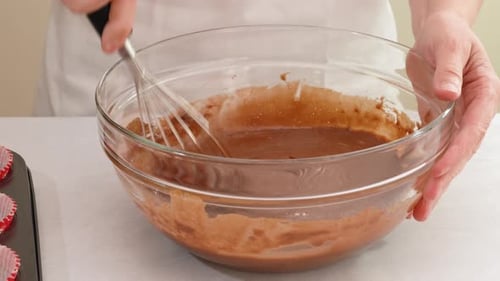 Mixing Chocolate Batter in Glass Bowl with Whisk