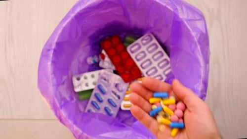 Throws Medicine Pills Into the Trash