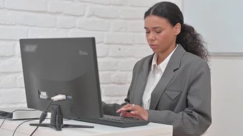 African Business Woman Working on Desktop Computer