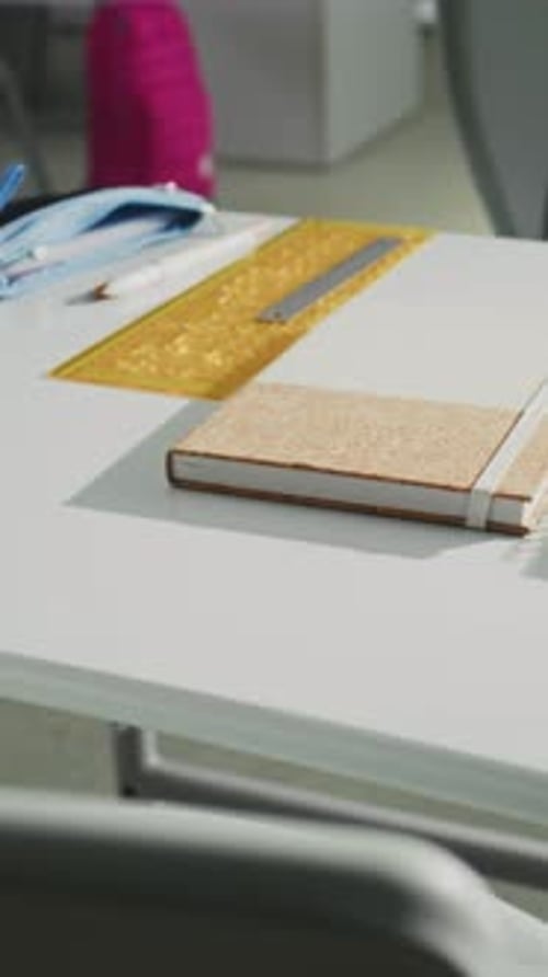 Close Up Shot of School Desk with Student School Supplies Pencil Case Pens and Pencils Notebooks
