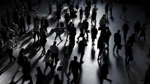 Silhouetted People Walking in Busy Urban Space