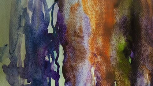 Brush spreading watercolor paint on colorful painting, close up