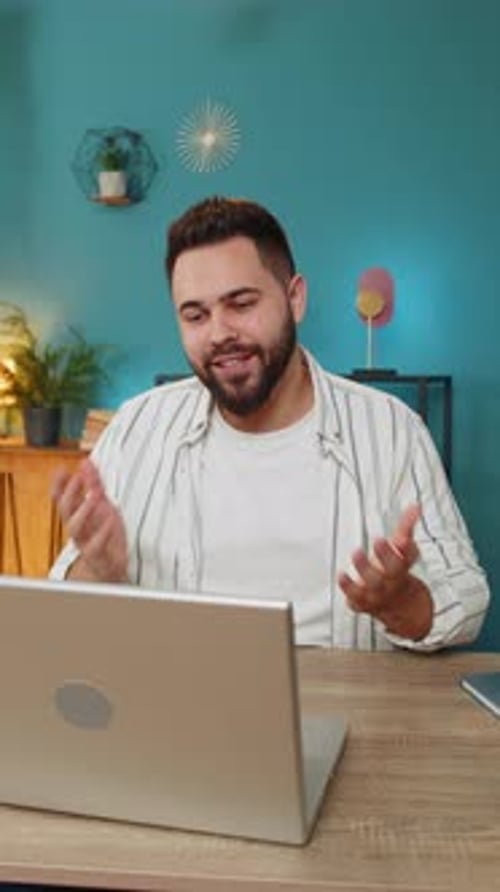 Young Adult on Video Call Using Laptop