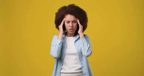 Woman Massaging Temples to Relieve Headache