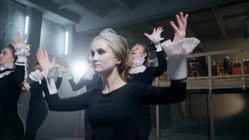 Troupe of Performers in Black Clothing and Makeup