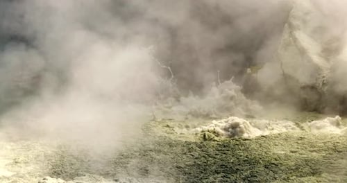 Toxic geothermal sulfur mud pool boiling water and emitting steam