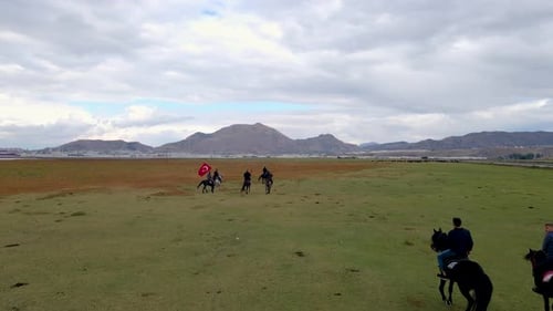 Horse Riders Traverse Green Field with Turkish Flag