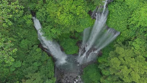 Aerial top down view of the stunning sekumpul waterfall cascading through a lush tropical