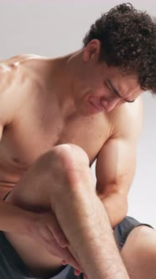 Fitness, calf pain and man in studio with injury, accident or muscle sprain for workout