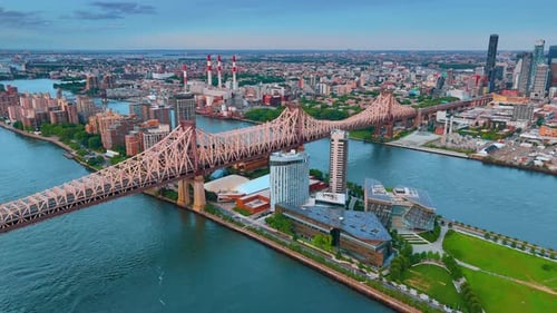 View on the Queensboro Bridge. Aerial perspective on the vast panorama of New York at sunset.