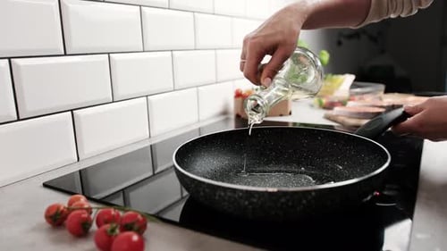 Woman Adding Oil to Frying Pan for Cooking