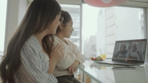Family Connects With Video Call on Laptop