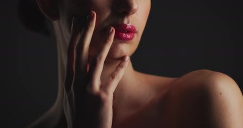 Woman with Red Lipstick Holds Hand to Face