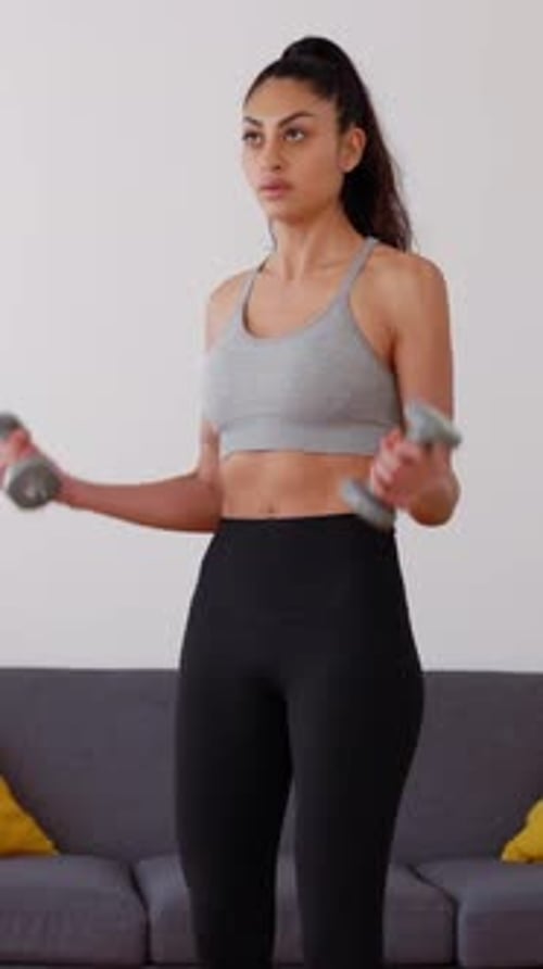Woman Doing Arm Exercises with Dumbbells at Home