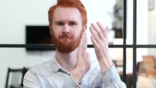 Man Smiling and Clapping Hands in Office