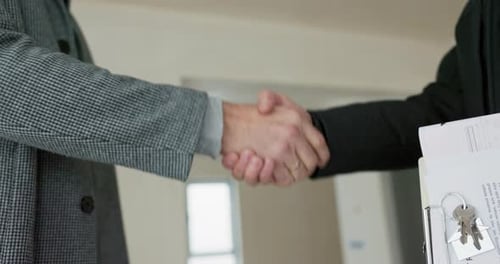 A Handshake Between a Real Estate Agent and a Man Buying an Apartment Thanking for the Meeting