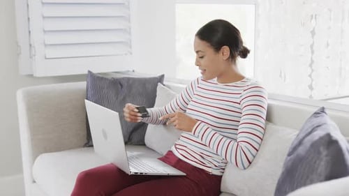 Woman Buys Online with Laptop and Credit Card
