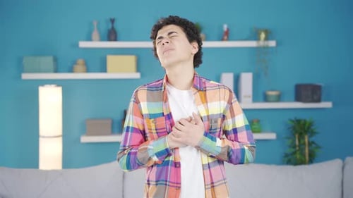 Boy suffering from heart palpitations or pain at home.