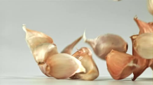 Fresh Garlic Falls on the Table Filmed on a Highspeed Camera at 1000 Fps