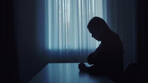 Silhouette sombre d'une femme inhalant un aérosol pour asthme