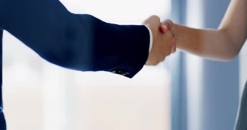 4k video footage of two unrecognizable businesspeople shaking hands together inside an office