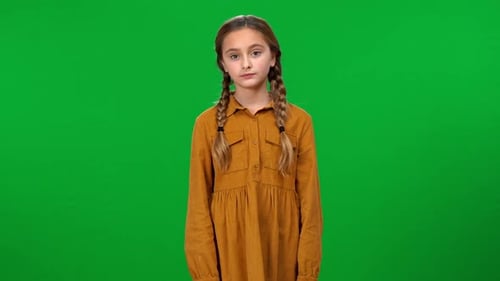 Cute Pretty Girl Standing on Green Screen Pointing Aside Smiling Looking at Camera Portrait of