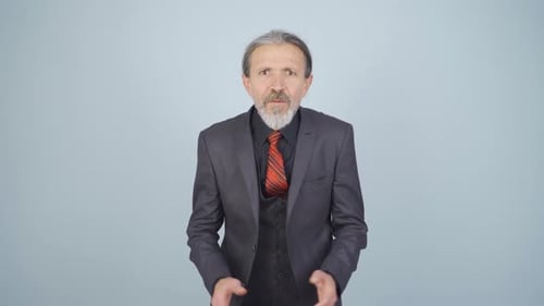Mature Man in Suit Gesturing and Talking