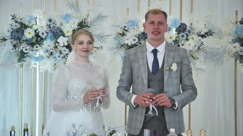 The Bride and Groom at the Table at the Banquet of Their Wedding