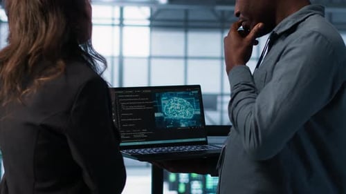 Professionals Discussing AI Technology on Laptop in Office