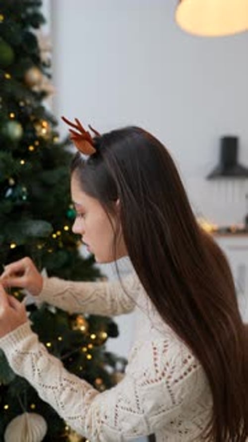Girl Decorating Christmas Tree with Star Ornaments