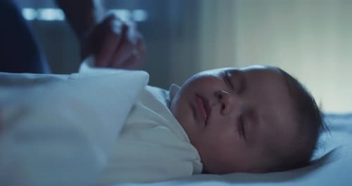 Authentic close up shot of cute newborn baby is sleeping while sleeping peacefully and comfortably