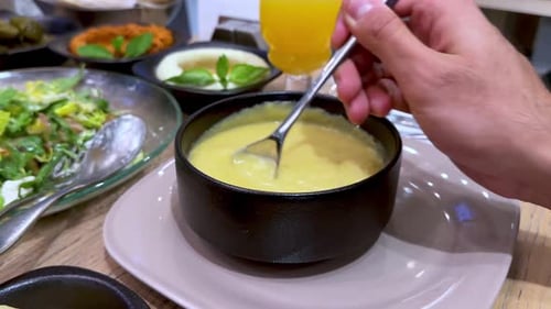 4K Dining Delight: Close-Up of Creamy Soup and Fresh Salad
