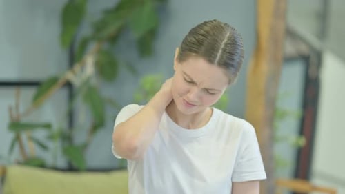 Casual Young Woman having Neck Pain, Stretching Body