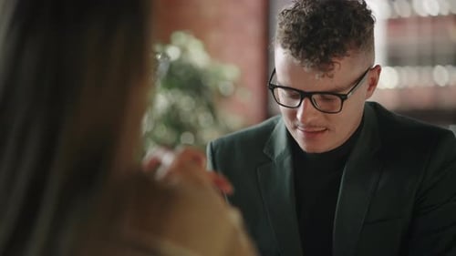 Man with Glasses Conducts Negotiations Talks and Conducts a Job Interview or Discusses Issues with a