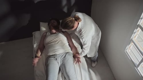 Man Receiving Care Lying on Bed