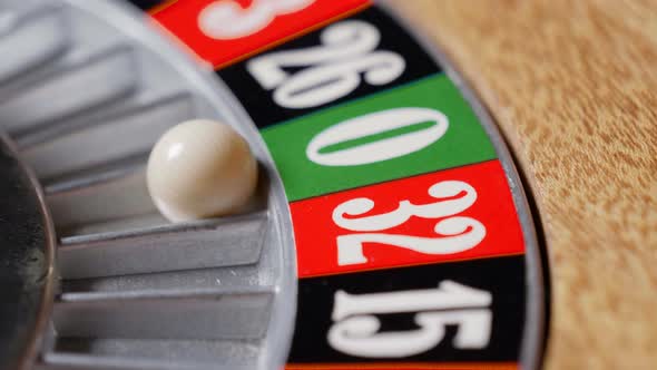 Macro shot of a roulette in a casino where the ball goes to the green ...