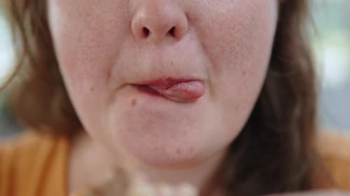 Adult Woman Eating and Licking Lips Close Up