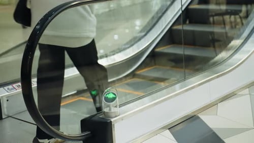 FirstPerson View of Climbing an Escalator in Motion at a Modern Shopping Mall