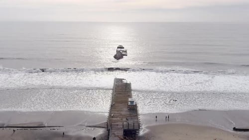 Aerial, aftermath of pier in Seacliff State beach destroyed by ocean storm