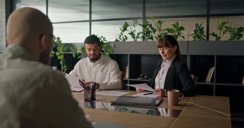 Business Team Discusses Data at Modern Office Table