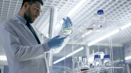 Scientist Inspecting Flask in Bright Laboratory Setting