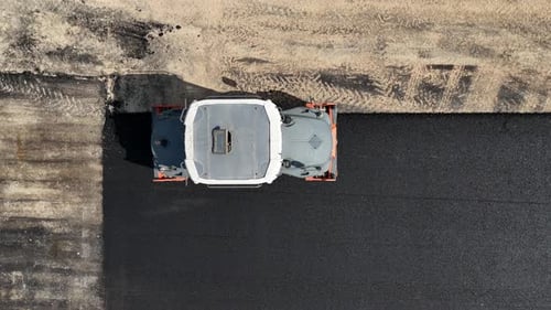 Road roller pressing fresh put Asphalt on a new road