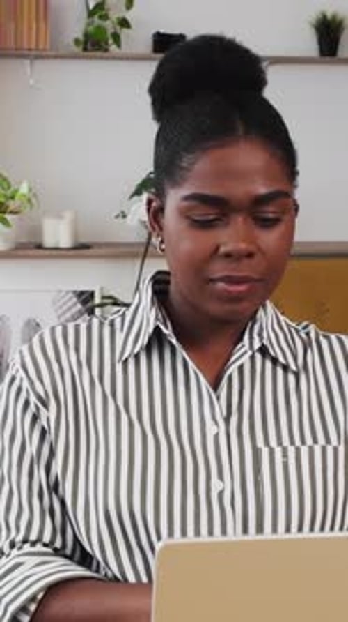 Young Adult African American Woman Working on Laptop Computer From Home