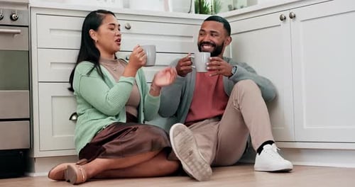 Happy Couple Relaxing with Coffee in Kitchen