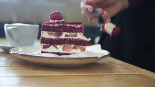 Enjoying Red Velvet Cake in a Cozy Cafe Setting