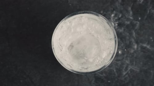 Bubbled Ice Water Glass Top View Closeup. Fizzy Soda Mineral Drink At